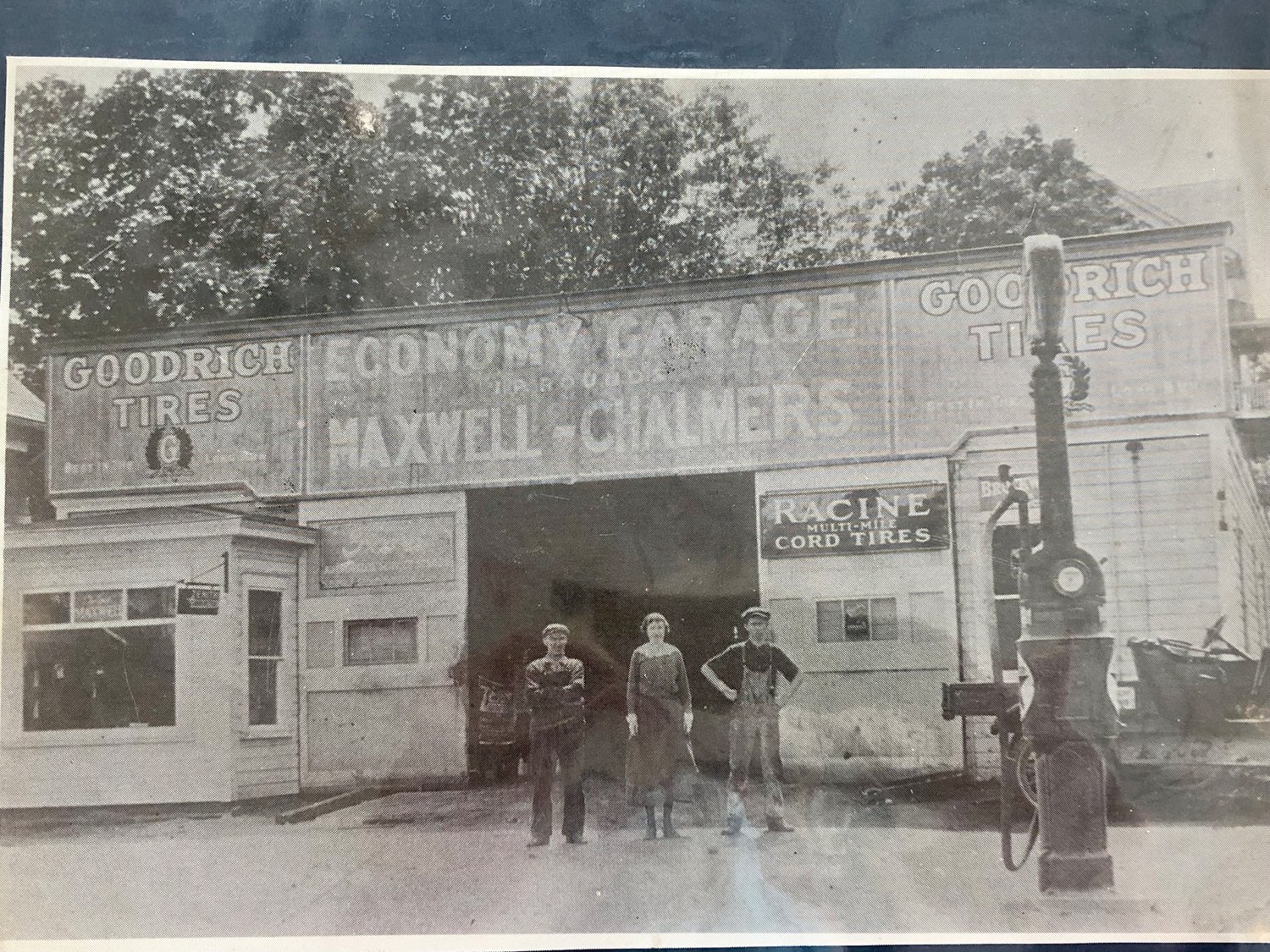 Israel Rounds, an unidentified woman, and 16-year-old Lewis Rounds at Apponaug’s Economy Garage around 1920.